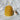 Golden beeswax candle shaped like a beehive from Bee Things collection with wick extension