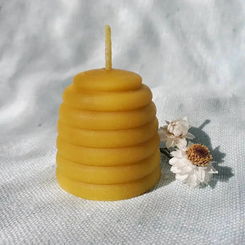 Golden beeswax candle shaped like a beehive from Bee Things collection with wick extension