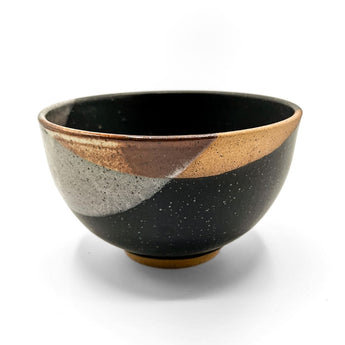 Handcrafted ceramic bowl with dark speckled base and light gray, brown, gold glazes in Bowls & Plates collection