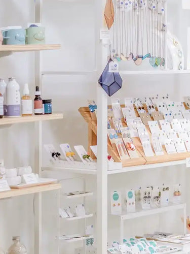 White retail shelving displaying beauty products and cosmetics.